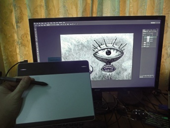My drawing tablet, stylus, and a drawing on the monitor I made with them.